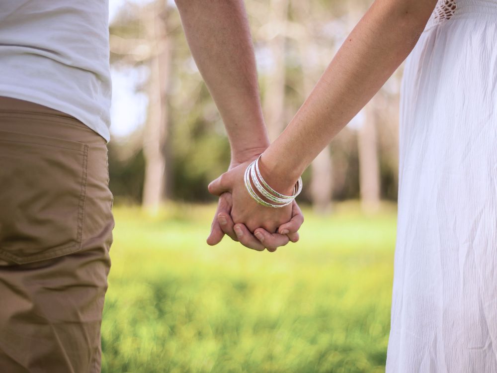 A man and woman holding hands